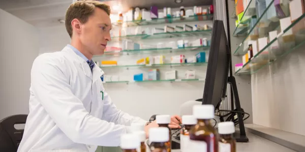 pharmacist typing on computer