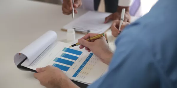 clipboard with charts on it and a doctor with a pen