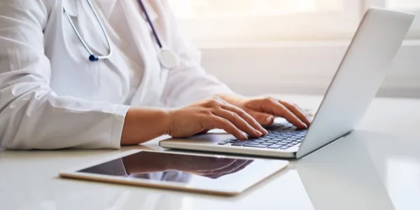 doctor typing on computer
