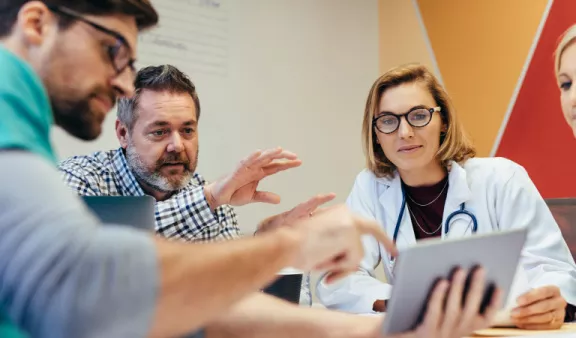 medical professionals looking at tablet