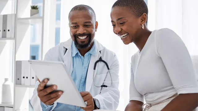 A doctor and a patient looking at a tablet