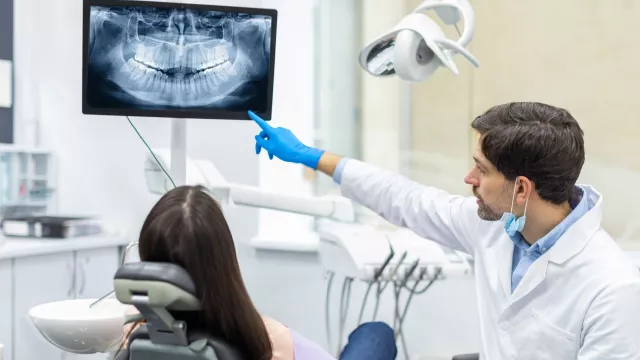 dentist and a patient looking at an x-ray