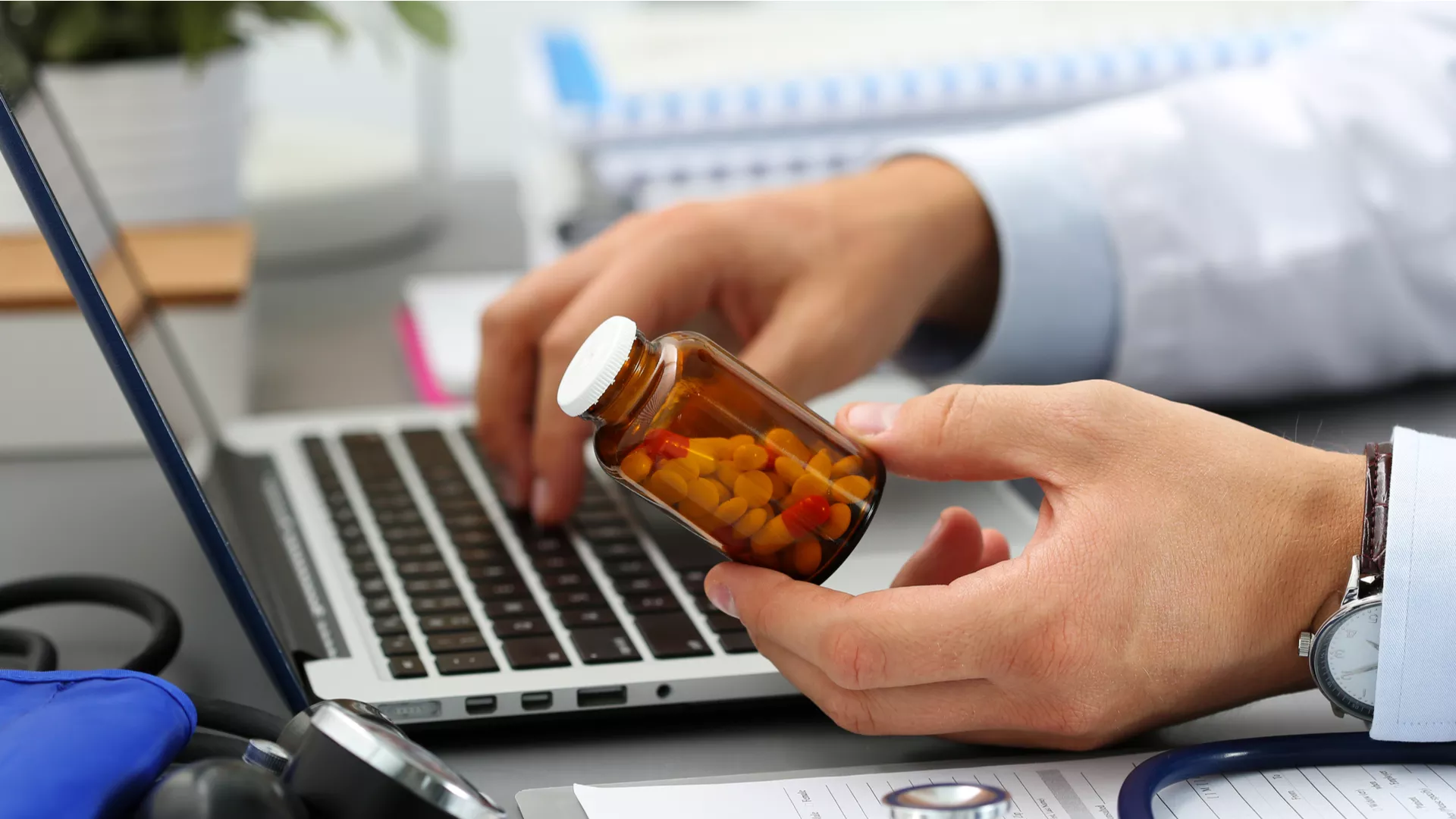 pharmacist looking at bottle of pills