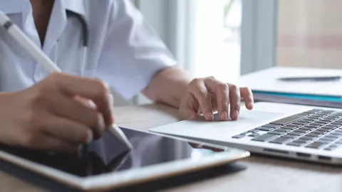 doctor using tablet and computer