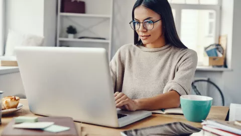 woman with brown hair working on a computer