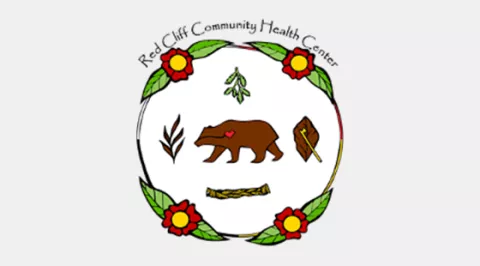 Logo of a bear with a garland around the outside and the words REd Cliff Coummunity Health Center